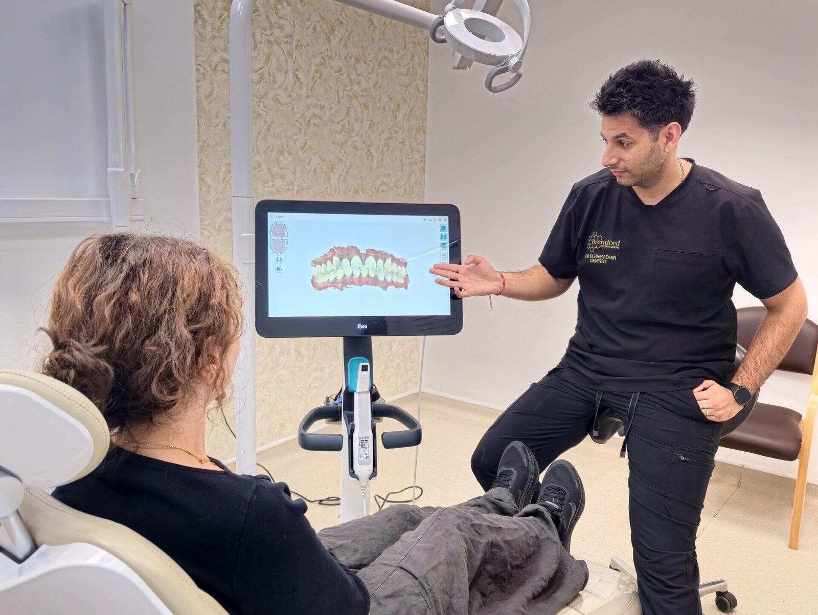 Dr Kerren Dhir beside the iTero digital scanner inside the practice